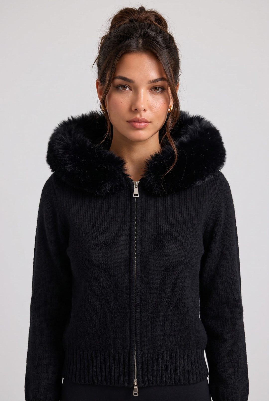 lily black knitted zip-up jacket with a plush faux fur hood worn by a woman against a neutral background